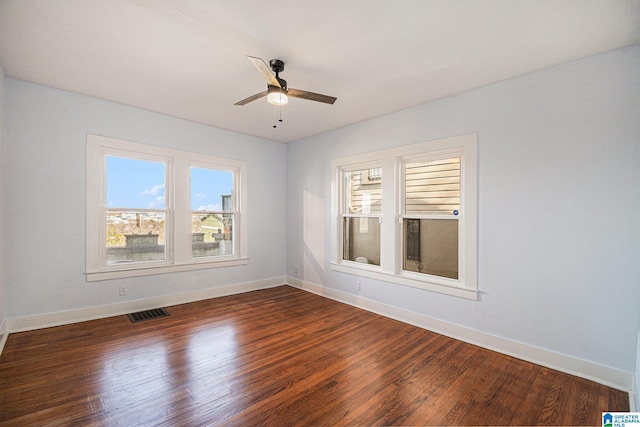 empty room featuring dark hardwood / wood-style floors and ceiling fan