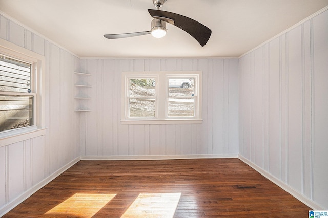 empty room with dark wood-type flooring and ceiling fan