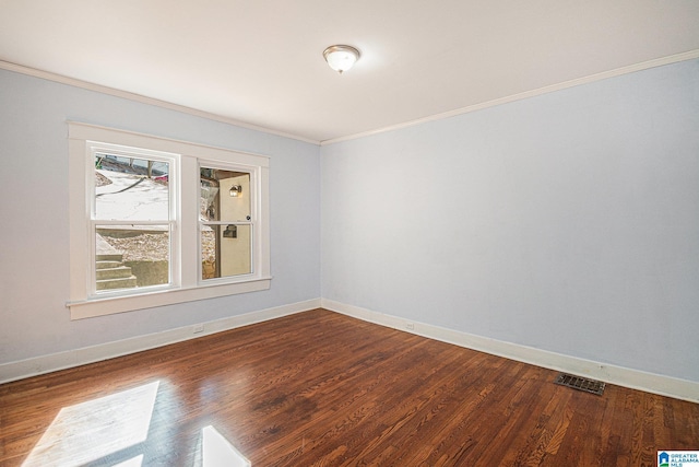 spare room with ornamental molding and hardwood / wood-style floors