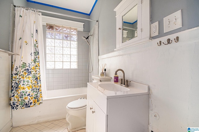 full bathroom featuring shower / tub combo with curtain, vanity, tile patterned flooring, and toilet