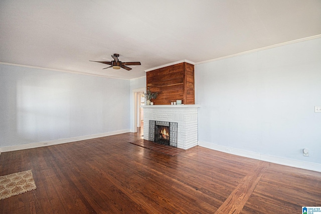 unfurnished living room featuring ornamental molding, dark wood-type flooring, ceiling fan, and a fireplace