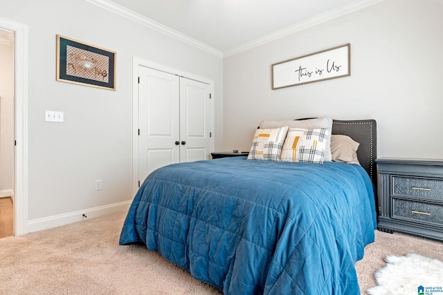 carpeted bedroom featuring ornamental molding and a closet