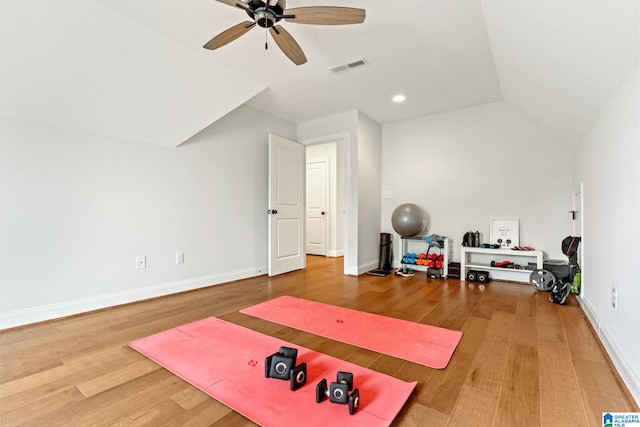 exercise area with ceiling fan, wood-type flooring, and vaulted ceiling