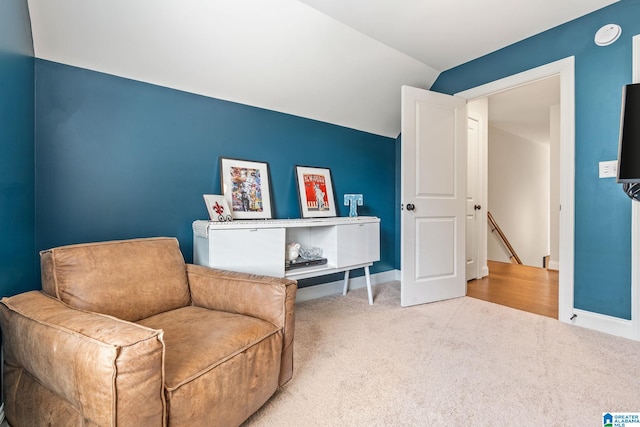 living area featuring vaulted ceiling and carpet floors