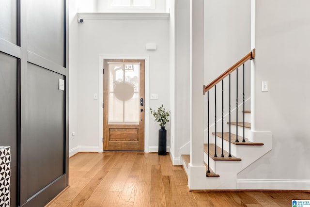 entrance foyer with light hardwood / wood-style floors and a high ceiling