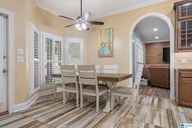 dining space featuring crown molding, light hardwood / wood-style floors, and ceiling fan