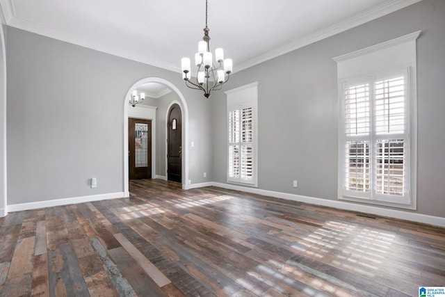 empty room with ornamental molding, dark hardwood / wood-style floors, and a notable chandelier