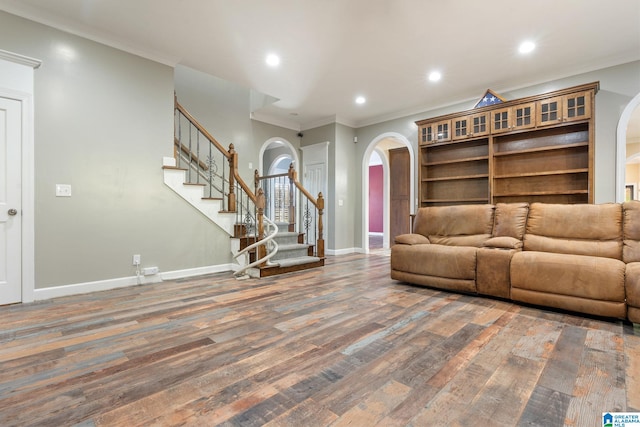 unfurnished living room featuring crown molding and dark hardwood / wood-style flooring