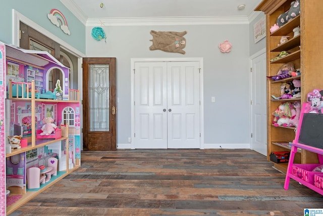 game room featuring dark wood-type flooring and ornamental molding