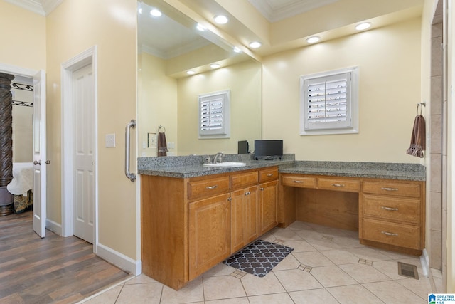 bathroom featuring crown molding, tile patterned floors, and vanity