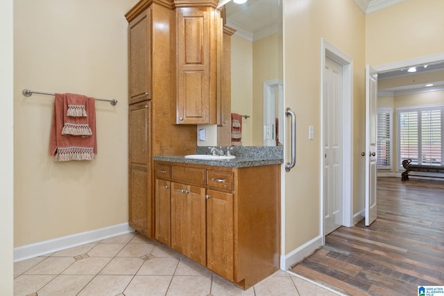 bathroom featuring tile patterned floors, ornamental molding, and vanity