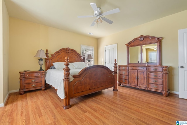 bedroom with multiple windows, ceiling fan, and light hardwood / wood-style floors