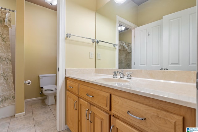 bathroom with vanity, tile patterned floors, and toilet