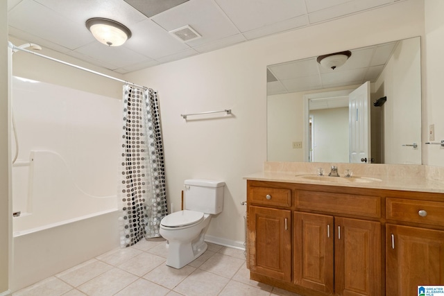 full bathroom with tile patterned flooring, vanity, toilet, shower / bathtub combination with curtain, and a drop ceiling