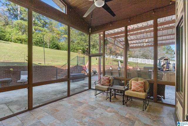 sunroom / solarium with lofted ceiling and ceiling fan