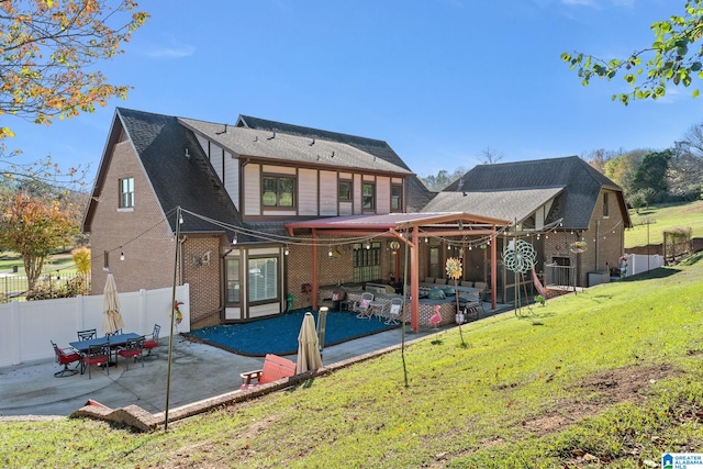 rear view of house featuring an outdoor hangout area, a yard, and a patio area