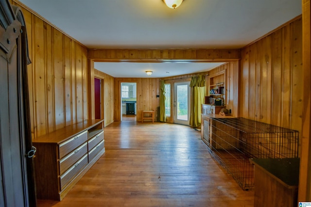 interior space with light hardwood / wood-style floors and wood walls