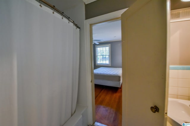 bathroom with wood-type flooring and shower / bath combo