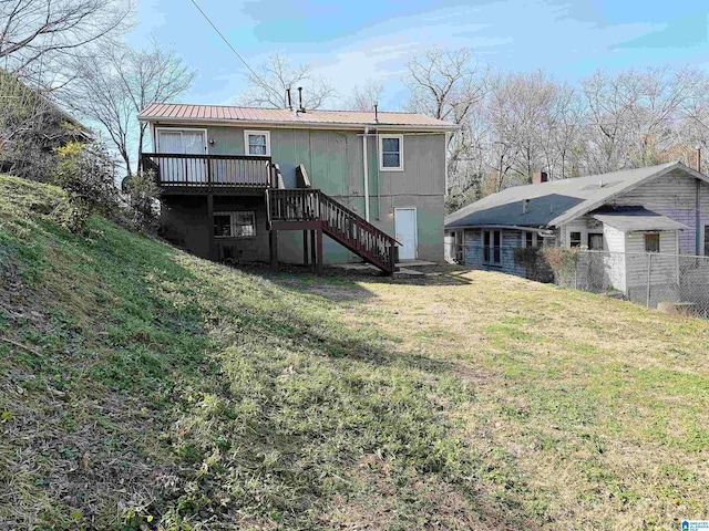 back of house featuring a yard and a deck