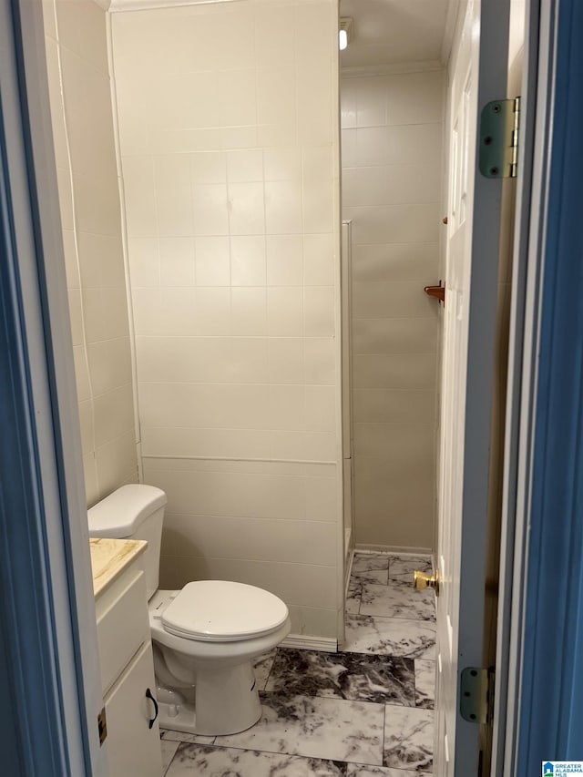 bathroom featuring ornamental molding, vanity, and toilet