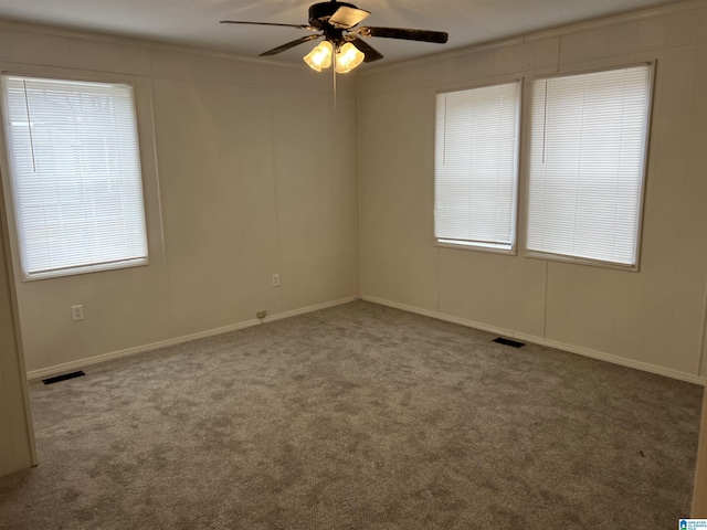 spare room featuring ceiling fan and carpet flooring