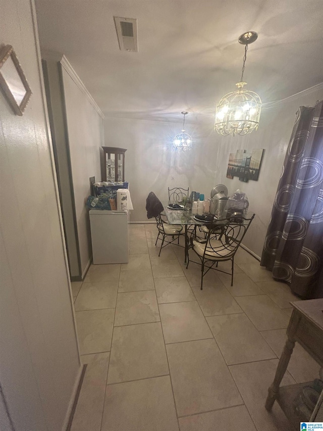 unfurnished dining area featuring crown molding, light tile patterned floors, and a chandelier