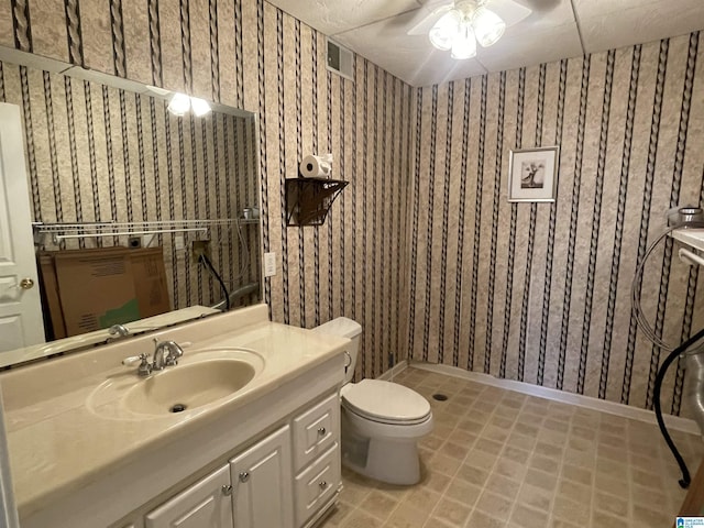 bathroom featuring vanity, a shower, and toilet