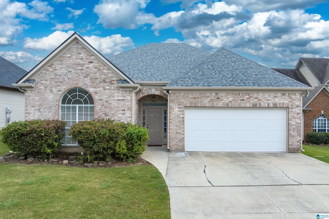 view of front of property featuring a garage and a front lawn