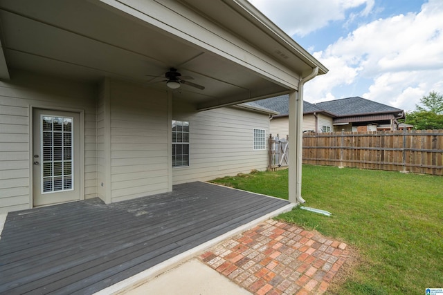 deck featuring ceiling fan and a lawn