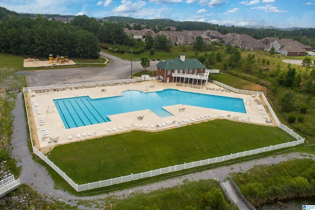 view of pool featuring a patio and a lawn