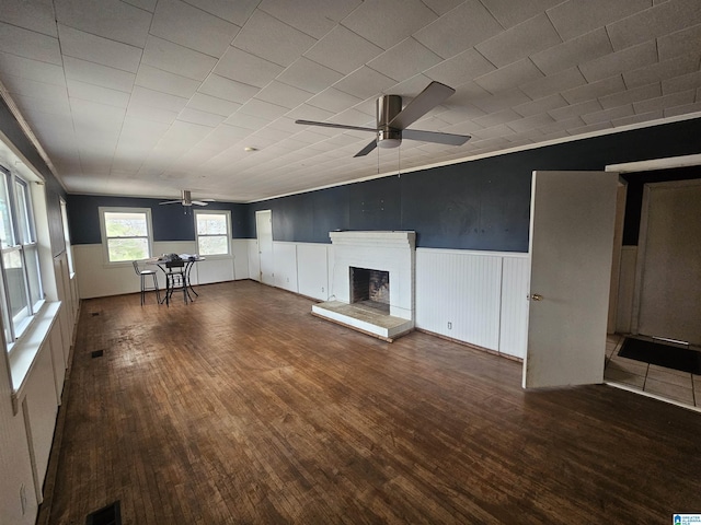 unfurnished living room featuring ceiling fan, vaulted ceiling, and dark hardwood / wood-style flooring