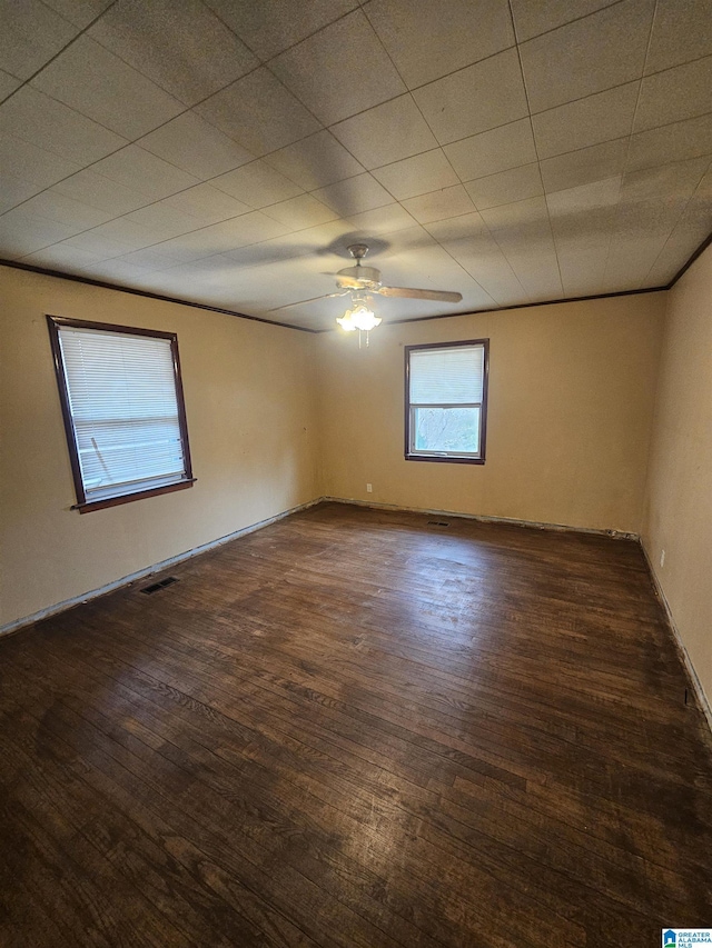 spare room with dark hardwood / wood-style floors and ceiling fan