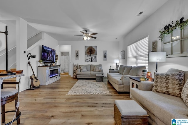 living room with ceiling fan and light hardwood / wood-style floors