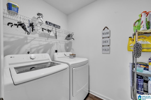 laundry room with separate washer and dryer and dark wood-type flooring