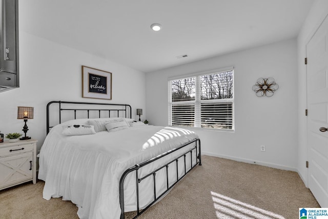 bedroom featuring light colored carpet