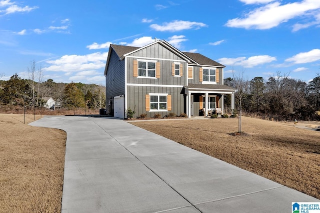 view of front facade with a porch, a garage, and a front yard