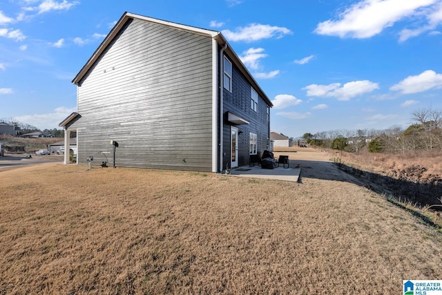 view of property exterior featuring a patio and a lawn