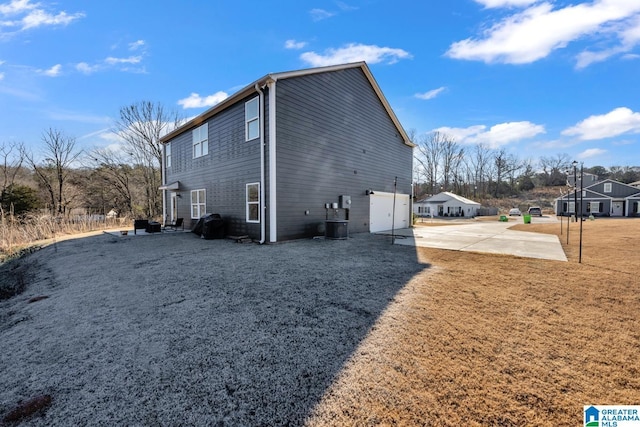 view of side of property featuring a patio and central air condition unit