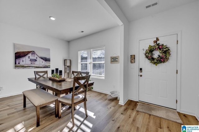 dining space featuring light wood-type flooring