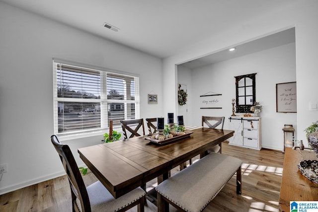 dining space with hardwood / wood-style flooring