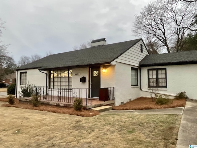 view of front of property with covered porch and a front yard