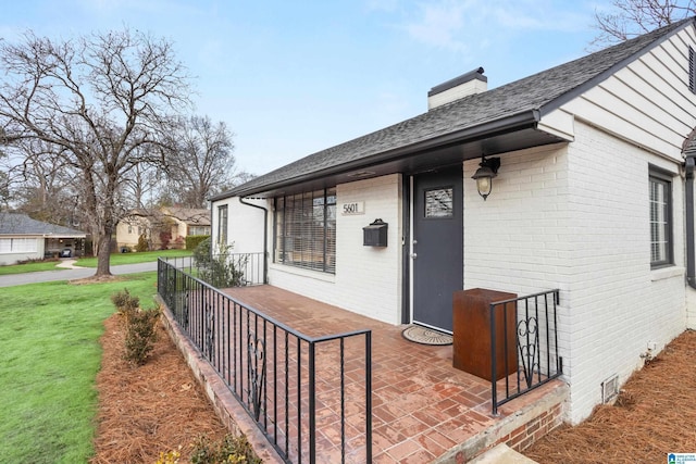 doorway to property with a yard