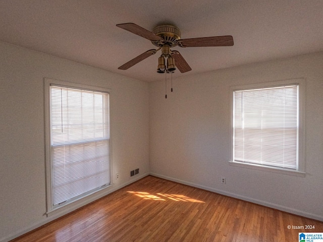 spare room with wood-type flooring and ceiling fan