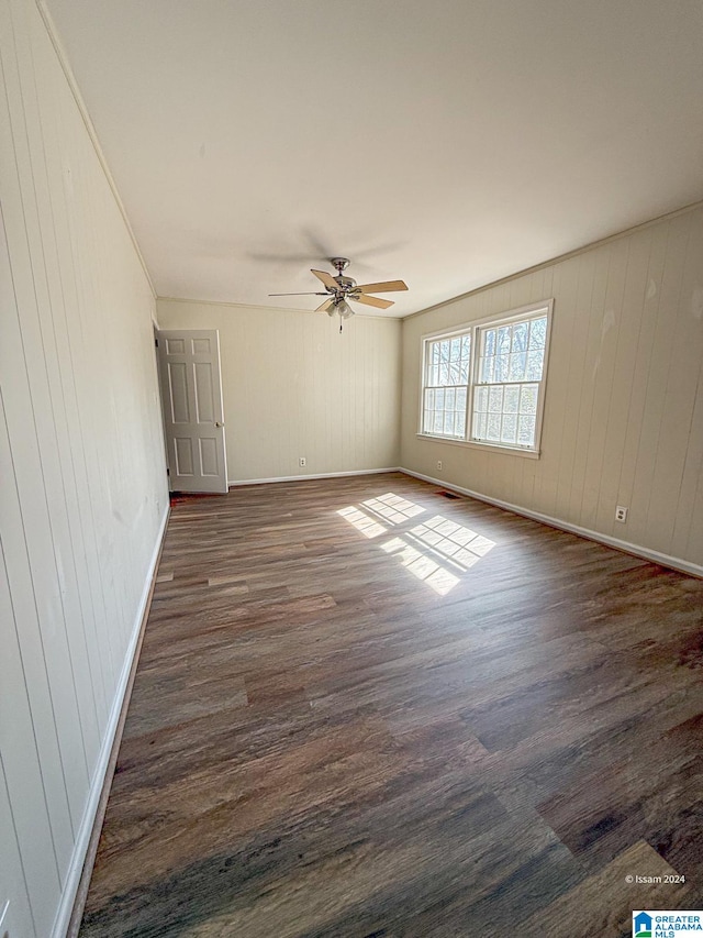 spare room with ceiling fan and dark hardwood / wood-style floors