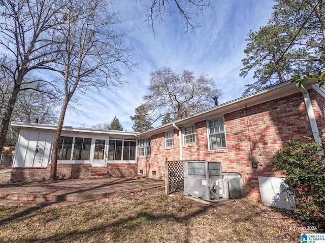 back of property featuring central AC unit, a patio area, and a sunroom