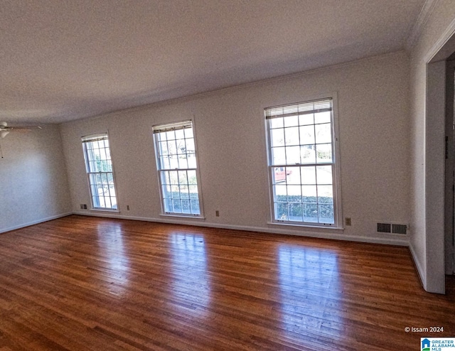 spare room with ceiling fan and dark hardwood / wood-style flooring