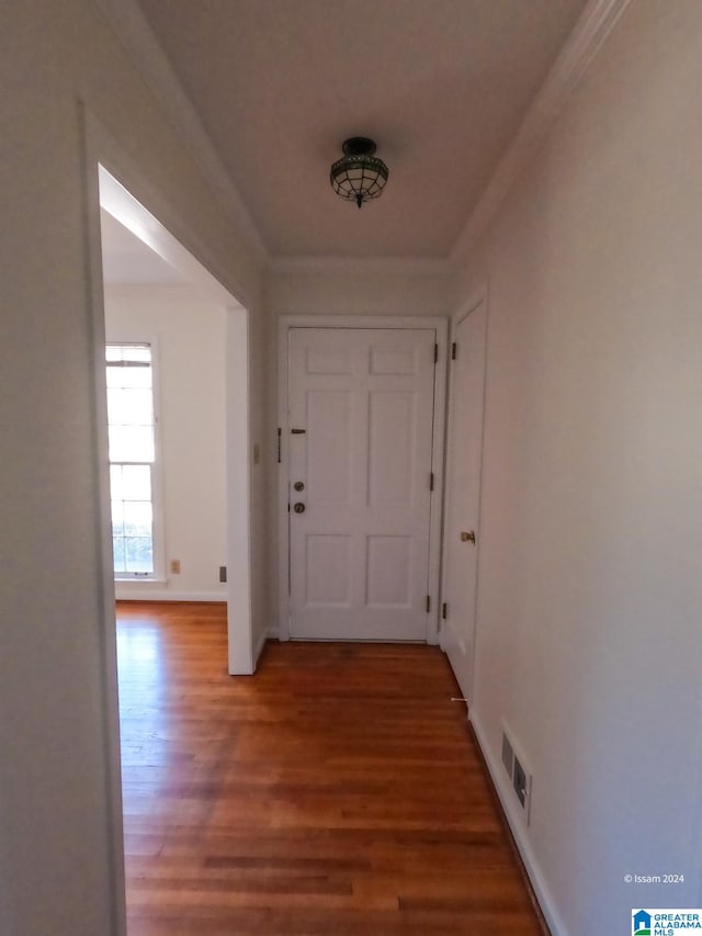 hall with hardwood / wood-style floors and crown molding