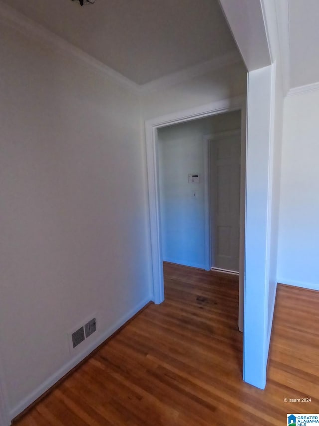 corridor with ornamental molding and dark hardwood / wood-style floors