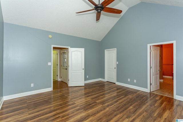 unfurnished bedroom with high vaulted ceiling, dark hardwood / wood-style floors, and ceiling fan