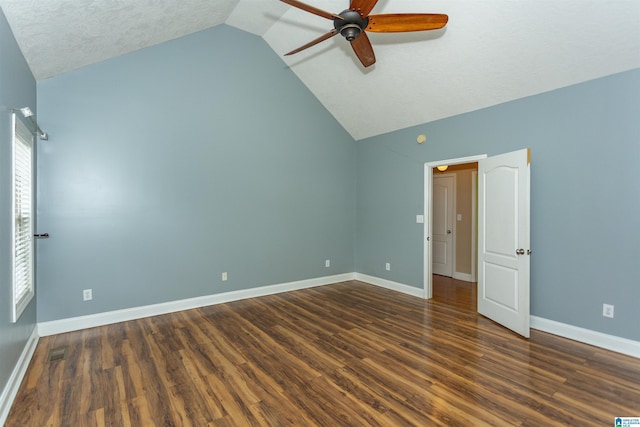 unfurnished bedroom with ceiling fan, lofted ceiling, dark hardwood / wood-style floors, and a textured ceiling